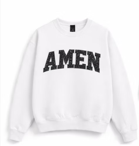 A white crewneck sweatshirt featuring the word 'AMEN' printed across the chest in a distressed black arched font, displayed against a clean white background.