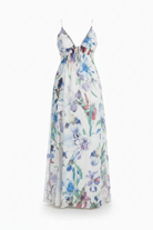 Woman in a floral dress standing on a city street