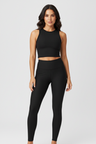 Black high-waisted leggings shown on a ghost mannequin against a light gray background.